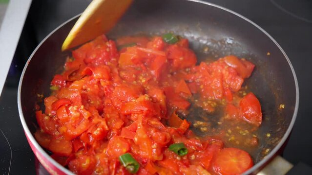 Delicious homemade vegetarian sauce bell peppers and hot pepper chilli. Cooking tasty lecho