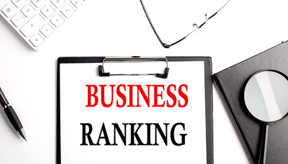 BUSINESS RANKING text written on paper clipboard with office tools