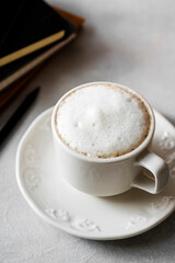Coffee cup with milk in white ceramic cup. Lifestyle morning drink photo