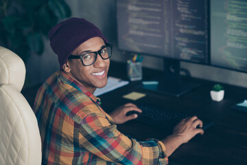 Profile photo of cheerful front end developer sitting chair keyboard typing operating server indoors