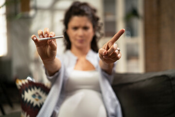 Beautiful pregnant woman refuses to smoke cigarette. Healthy life choice