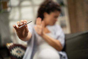 Beautiful pregnant woman refuses to smoke cigarette. Healthy life choice