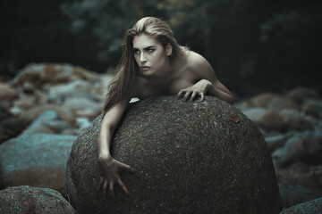 Dark female hunter rising from stones