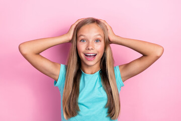 Photo of funky excited little child dressed teal t-shirt pointing arms head smiling isolated pink color background