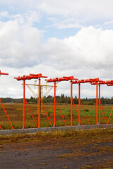 Fototapeta na wymiar orange sticks and scaffolding at the beginning of the airport near the runway