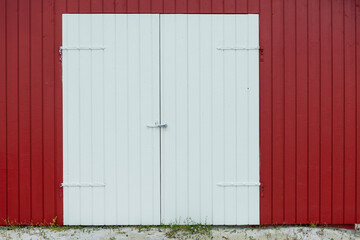 Red door and exterior clapboard wall - stock photo