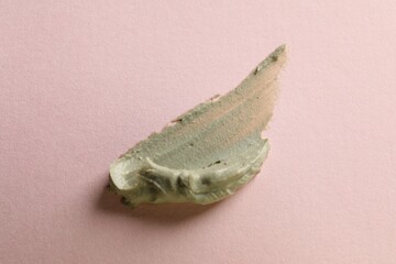 Sample of face cream on pink background, top view