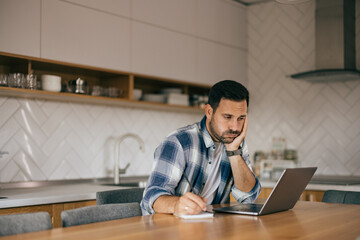 A man looking bored, working all day, feeling tired.