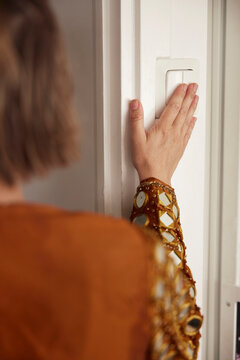Woman turning on light