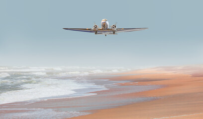 Fototapeta na wymiar A Propeller plane flying on the beach 