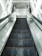 Escalator in a shopping mall. There are footprints blue color,scroll down Department store.