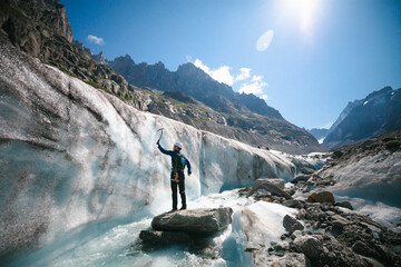 Man with pickax exploring mountains in winter