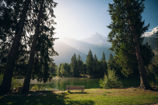 Bench next to mountain lake
