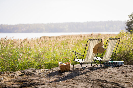 Empty Lounge Chairs On Rock