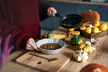 Close up of caucasian woman preparing warming soup