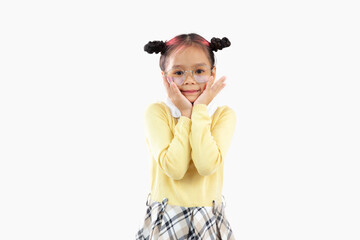 Cute asian girl in yellow sweatshirt posing hands on face white background.
