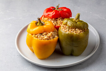 Fototapeta na wymiar Stuffed peppers made with colorful bell peppers. A delicious stuffed pepper with bulgur and meat.