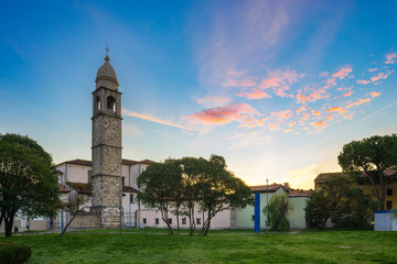 Stone belfry at dawn. View of San Giorgio church from a public garden. Sunrise over classic Italian...