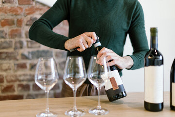 sommelier opening bottles of wine preparing wine tasting