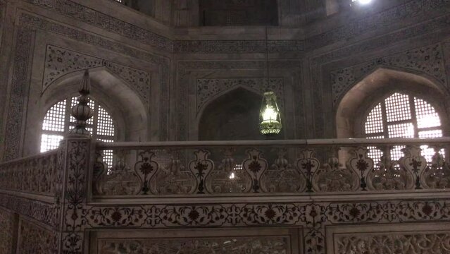 Agra, India, November 2019 - A large building with a clock on the front of a mirror