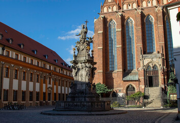 Fototapeta na wymiar Monument to John of Nepomuk in Wroclaw, representing a saint surrounded by angels and holding a crucifix in his hand. Around the head of St. John is a halo of five stars