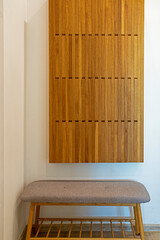 wooden stylish piano hanger in a minimalist interior in the hallway, vertical