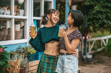 Two girls drinking lemonade and looking pleased