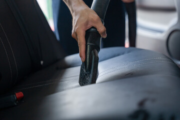 Man's hand is cleaning car at garage