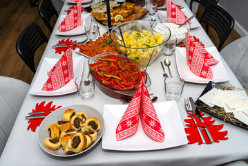 A table set before Christmas dinner with many traditional Polish dishes.