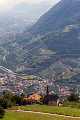 Fototapeta premium A view of Meran and the surrounding valley at evening time in the South Tyrol