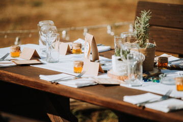 Wedding decoration table in brown and white colors with wood and glass
