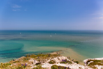 Sailboats on the color waters of Beachy Head in southern England on a beautiful summers day
