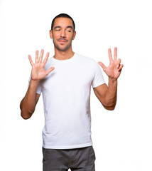 Happy young man doing a number eight gesture with his hands