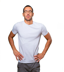 Tired young man posing against background