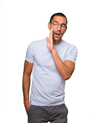 Confident young man telling a secret