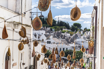 narrow cobblestone streets and round stone trulli houses in Arbelobello. Stone pointed roofs and...