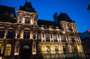 Fototapeta premium Paris Tourism Office is in the north wing of the Hotel de Ville (City Hall) located in famous le Marais district, Paris, France. Night scene, lit up building