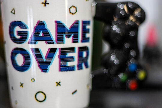 Mug with the message Game OVER. Gamer concept.