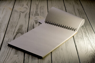 Opened blank notebook with checkered tear-off leaves