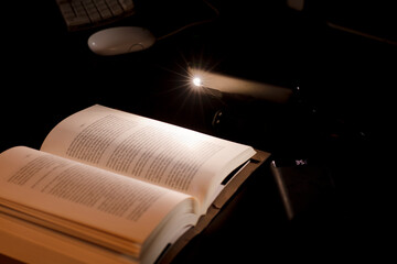 cell phone and power bank on the desk illuminates reading and study book with battery-powered...