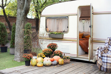 Wooden RV house porch with garden furniture. Campsite in garden. Wooden armchair near outside...