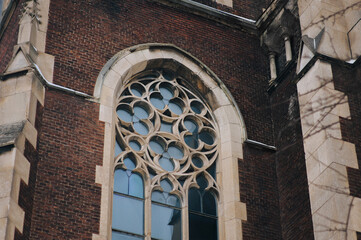 Elongated vintage window on the facade of the ancient building. Baroque and Gothic architecture....