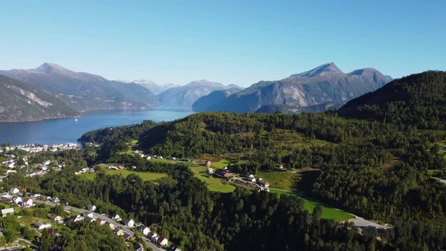 Drone view of the Stranda village surrounded by forests and mountains in Norway