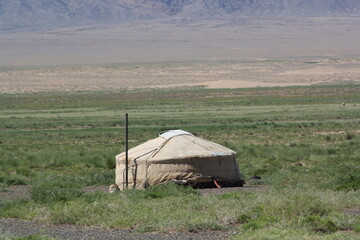 The nomadic tent (ger) in the lonesome desert, Gobi, Umnugovi, Mongolia. The desert is hot in the summer afternoon and is cold in the night. Some deserts have dense vegetation. 