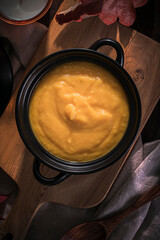 creamy pumpkin soup in a black pot