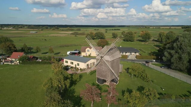 Old flour mill. Buttery soft aerial view flight point of view POV drone shot
of a Trestle windmill in brandenburg Germany at summer golden hour 2022. 4k marnitz Cinematic