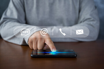 Contact us or Customer support hotline people connect. Businessman using smart phone and touching on virtual screen contact icons