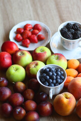 Various healthy seasonal food arranged on wooden background. Selective focus.