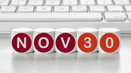Letter dice in front of a keyboard - November 30