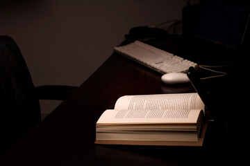 cell phone and power bank on the desk illuminates reading and study book with battery-powered...